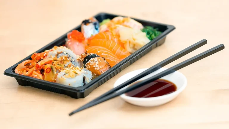Zestaw sushi z nigiri i maki na talerzu z pałeczkami